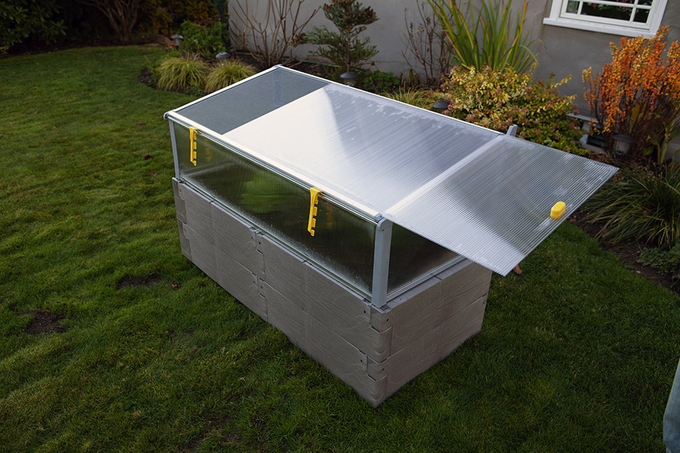 gray timber raised bed with cold frame sliding top panel